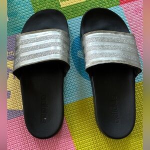 Silver and black adidas slides
